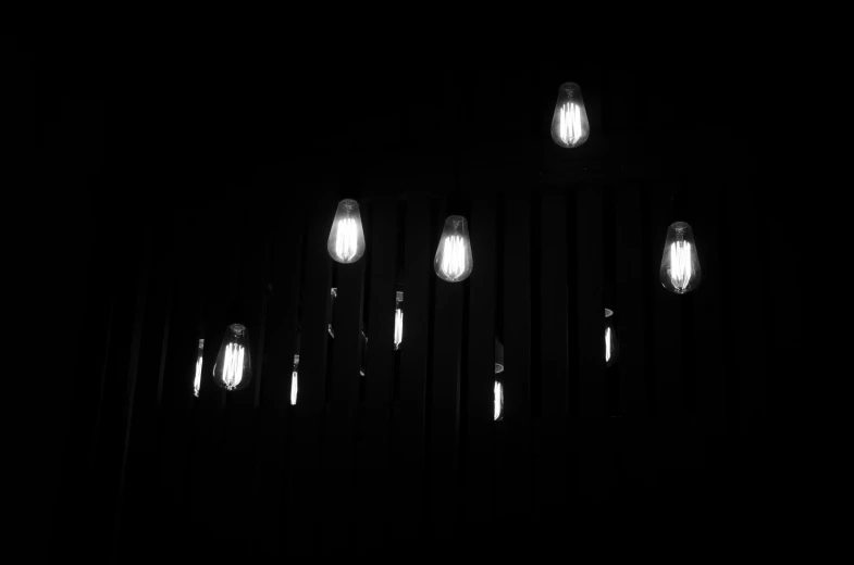 a cluster of white lights that are on a wall