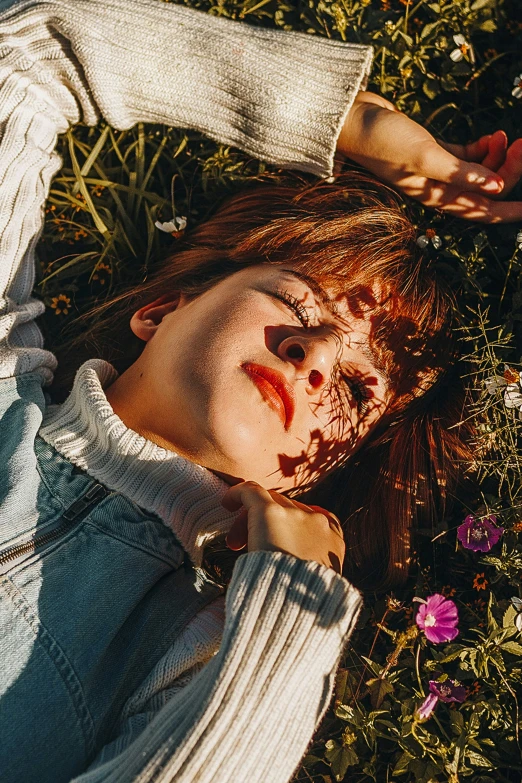 a woman with her face painted red in the grass