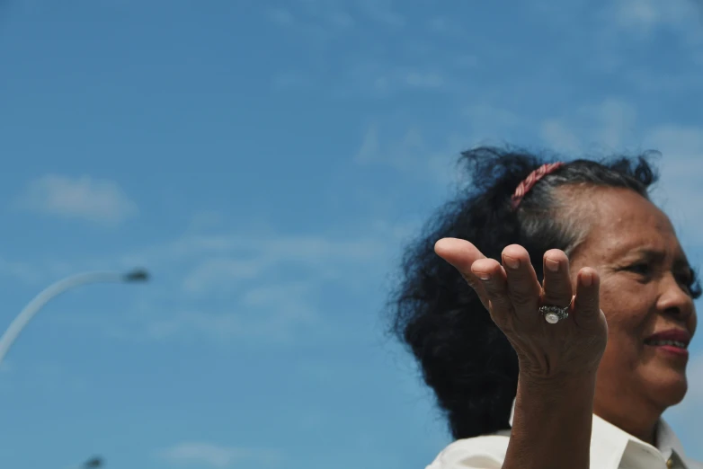 a close up of a person with her hand in the air