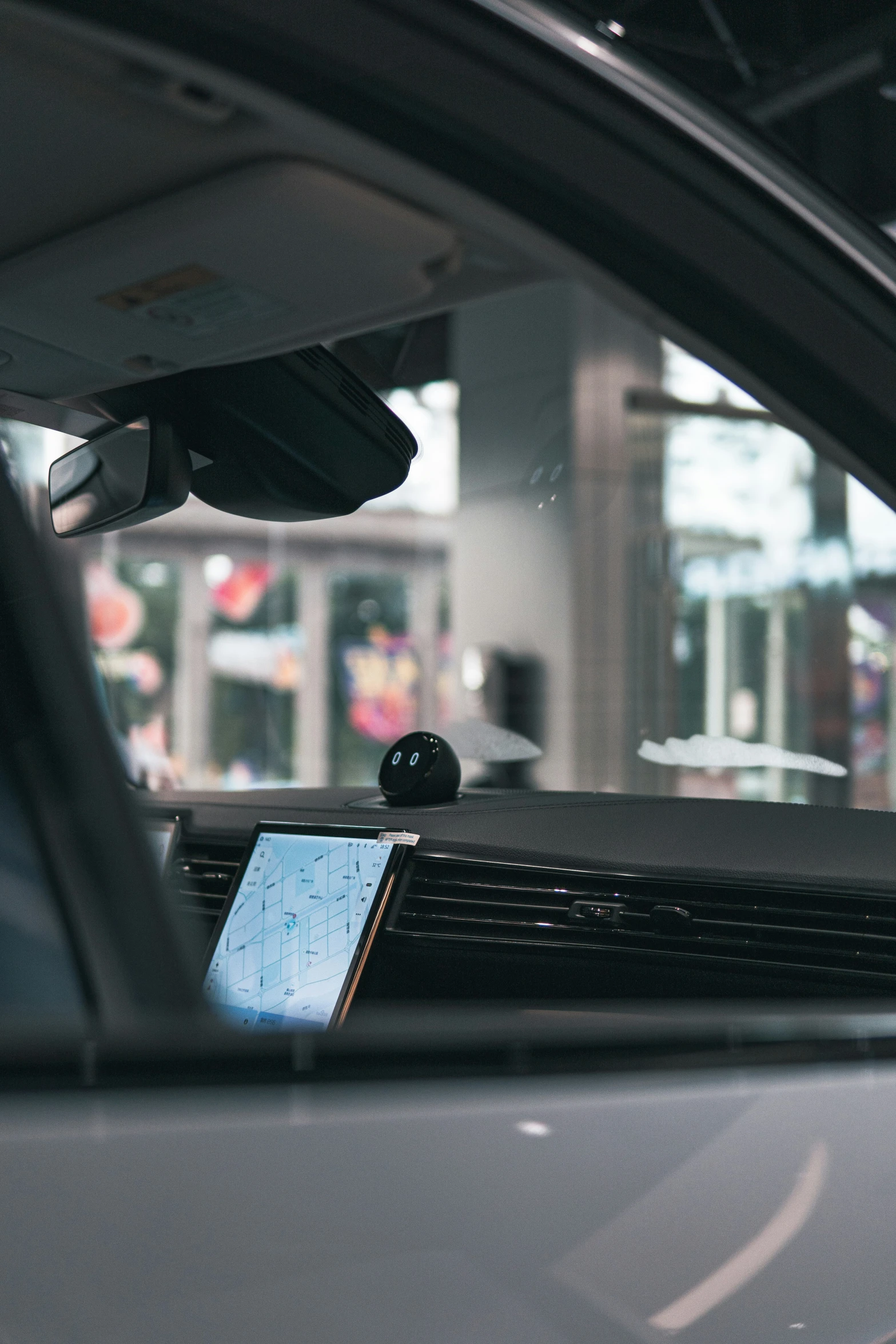 a car with dashboard, windows and an electronic device