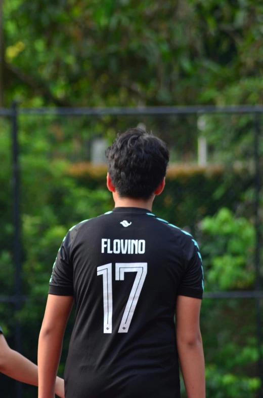 two young men with black jerseys standing near each other