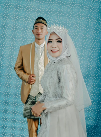 a man and woman in wedding outfits, posing together
