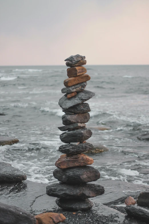 a stack of rocks sitting on top of a beach