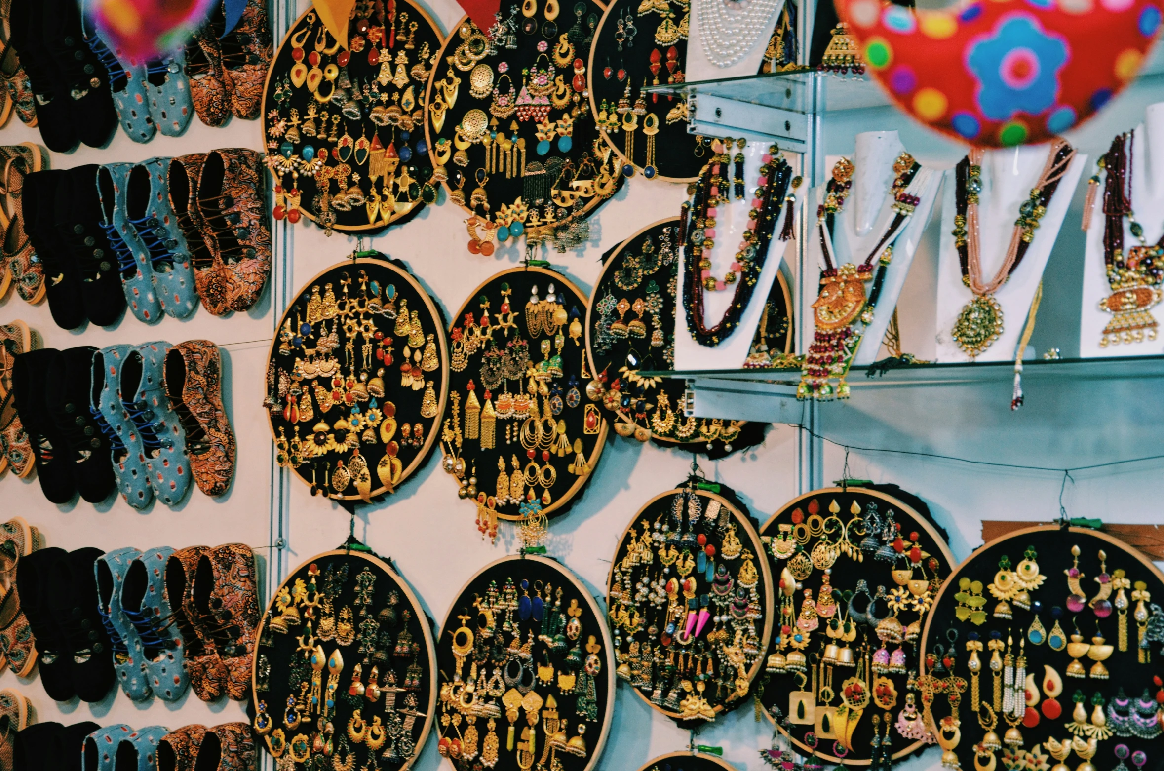 a wall full of many different necklaces and earring hooks