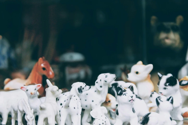 many toy animals are on a shelf in the store