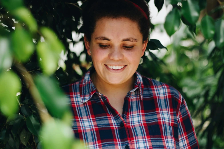 a young woman is smiling while looking down