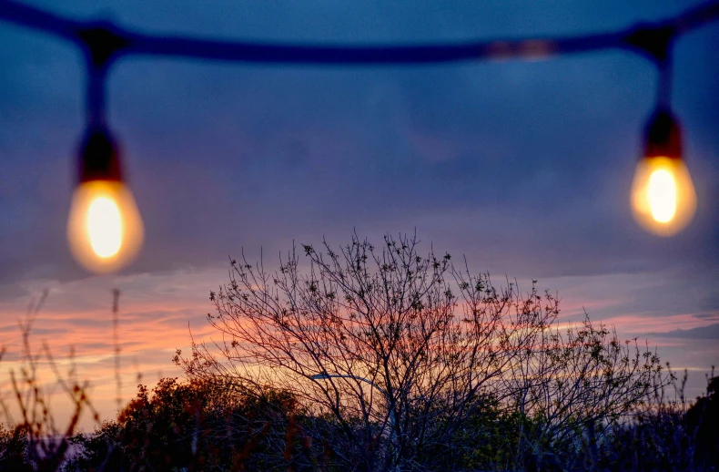 a street light sits in front of the sky