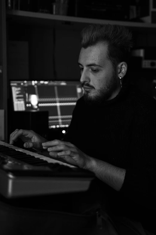 a man sitting in front of a computer keyboard