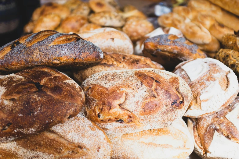 assorted breads, pastries and loaves on display for sale