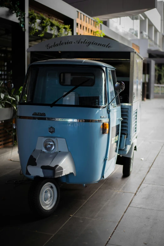 a scooter with its canopy off parked on a sidewalk