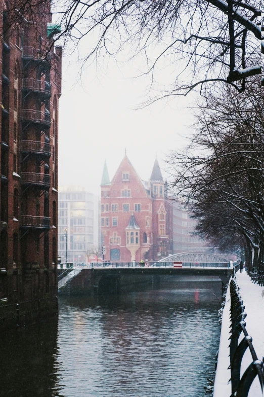 a snow covered river and buildings along side