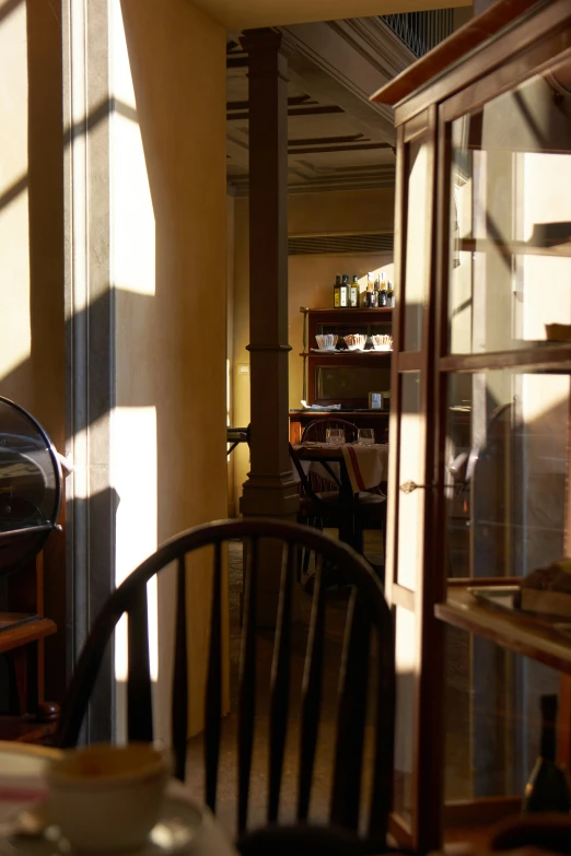 the light is shining through the glass doors onto the dining room