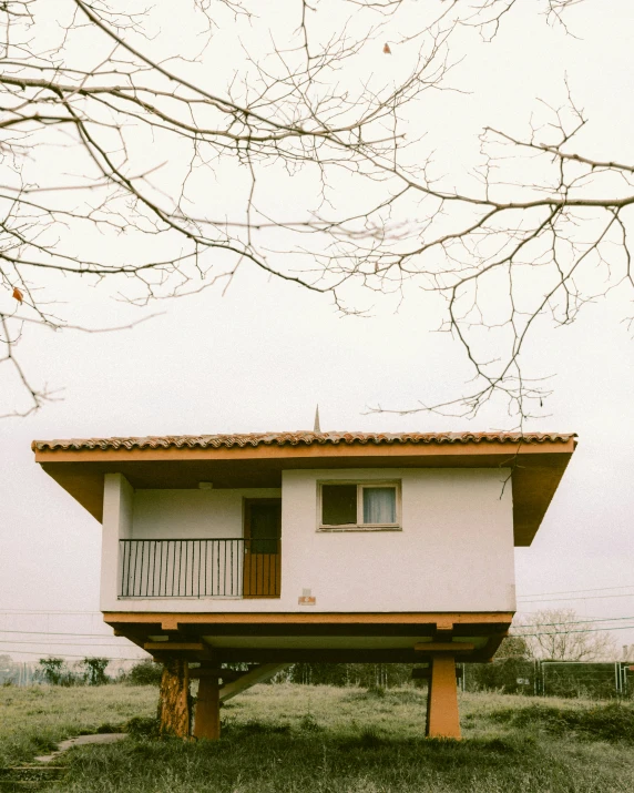 a small house sitting in a grassy field