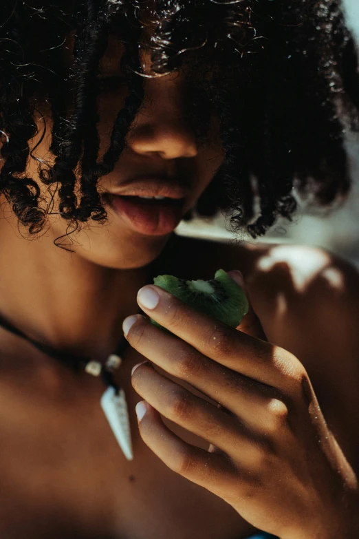 a girl with curly hair is holding a phone