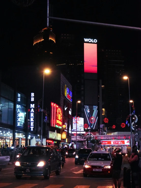 a city filled with lots of traffic under tall buildings