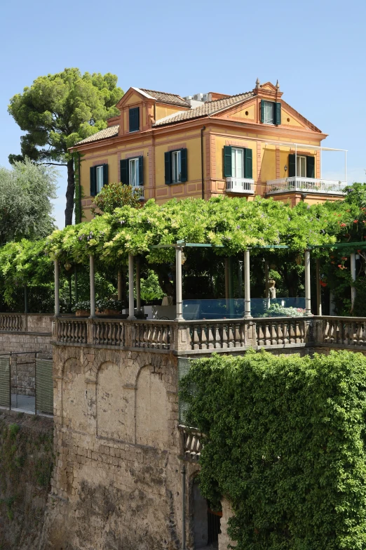 an outdoor swimming pool and pavilion in front of an old - fashioned mansion