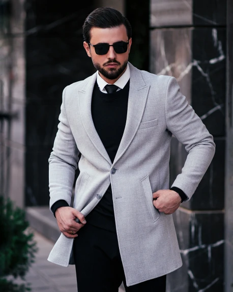 man in a suit with sunglasses walking down the street