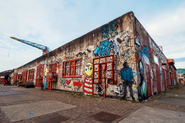 graffiti covers the side of a building in a city