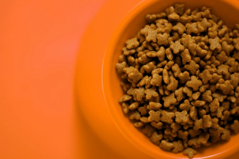 a bowl filled with lots of food on top of an orange counter