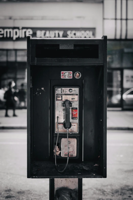 a phone booth on the street outside a business