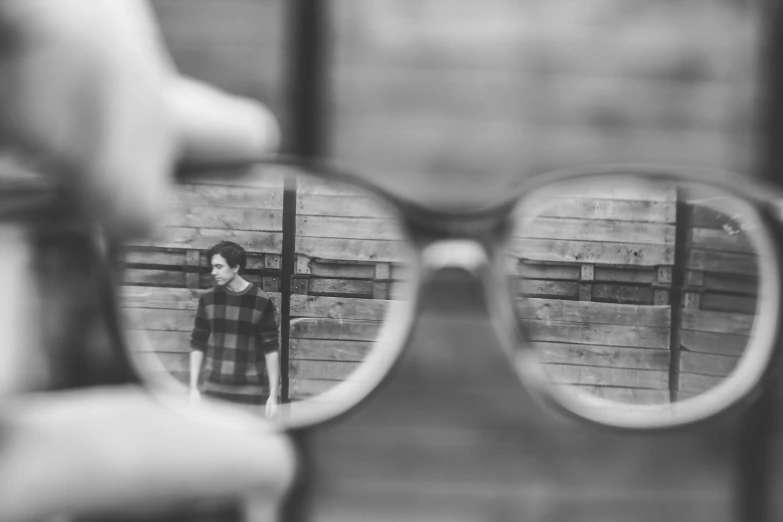 the person is seen through glasses looking at it