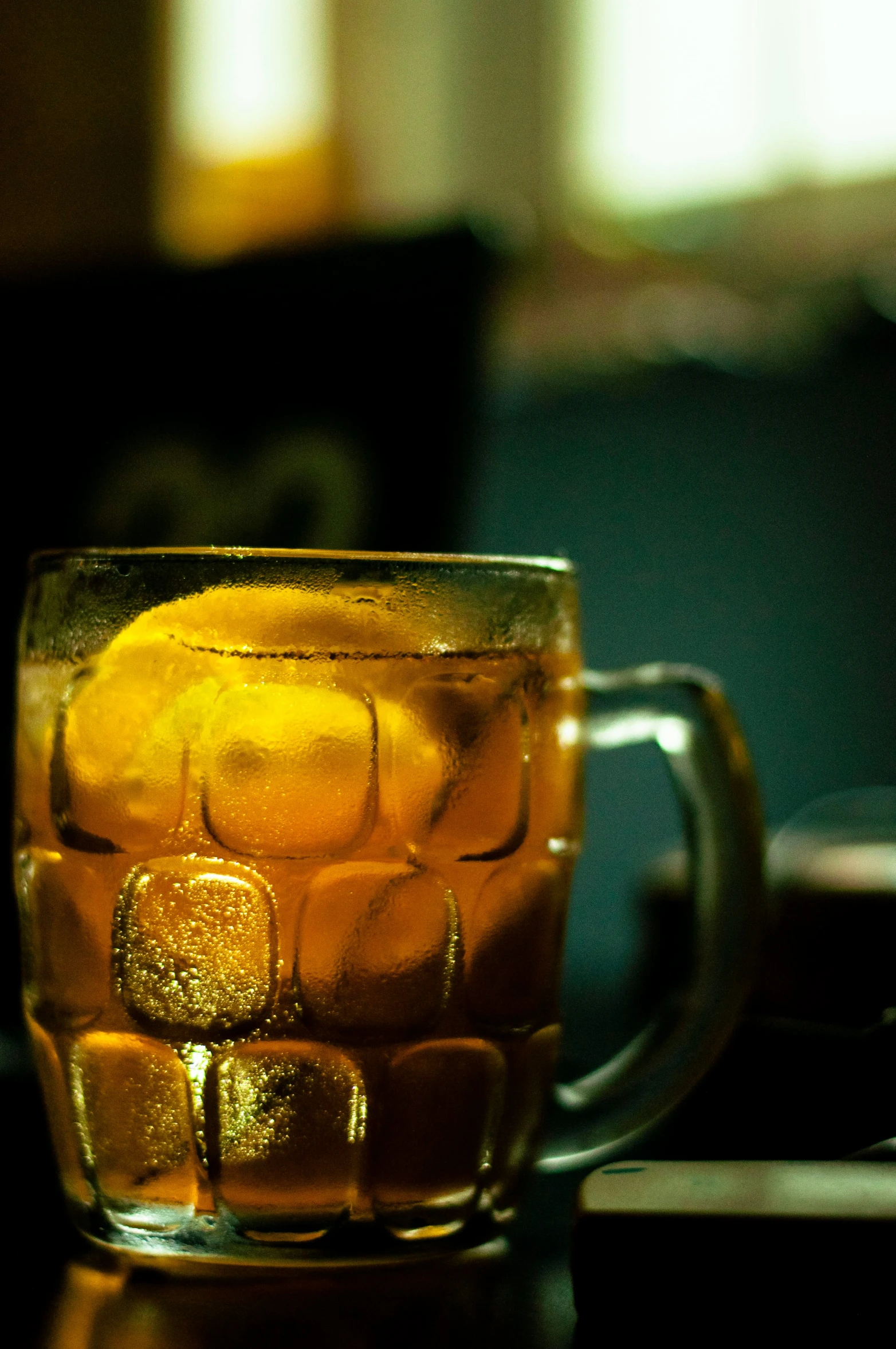 a glass mug with ice cubes in it