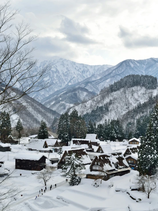 a snow covered hillside that has houses on it