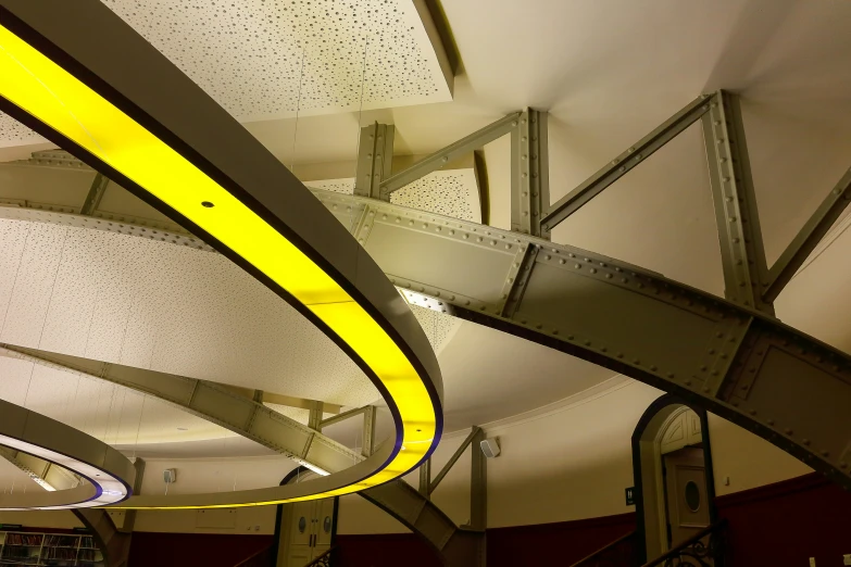 there are circular yellow lighting fixtures with a circular design above them