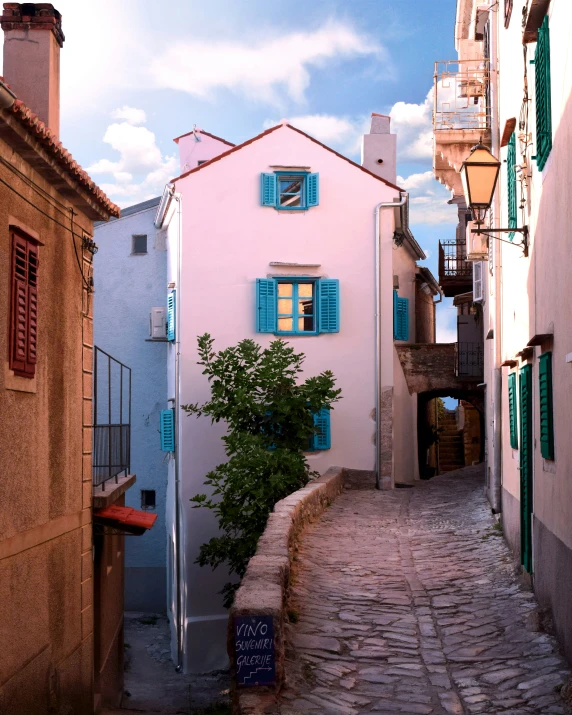 street with a cobblestone sidewalk lined with buildings