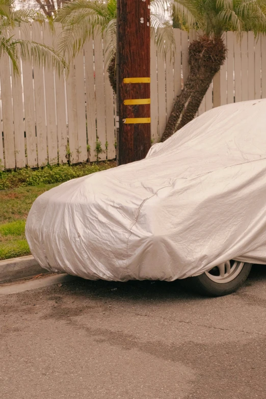 there is an old car covered in a white cloth