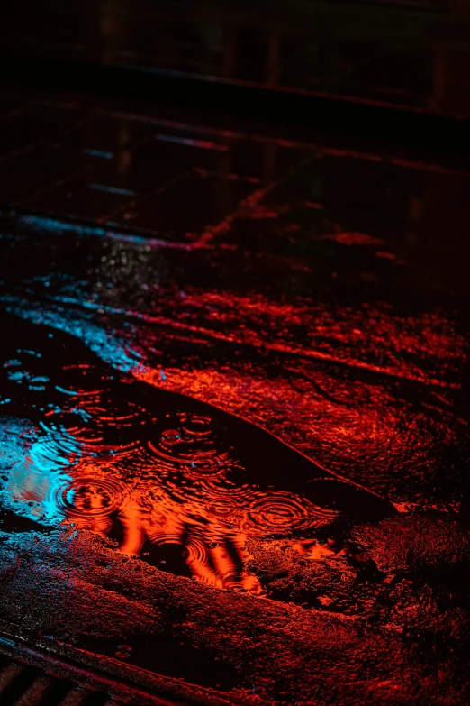 a sidewalk has a very dark and colorful light on it