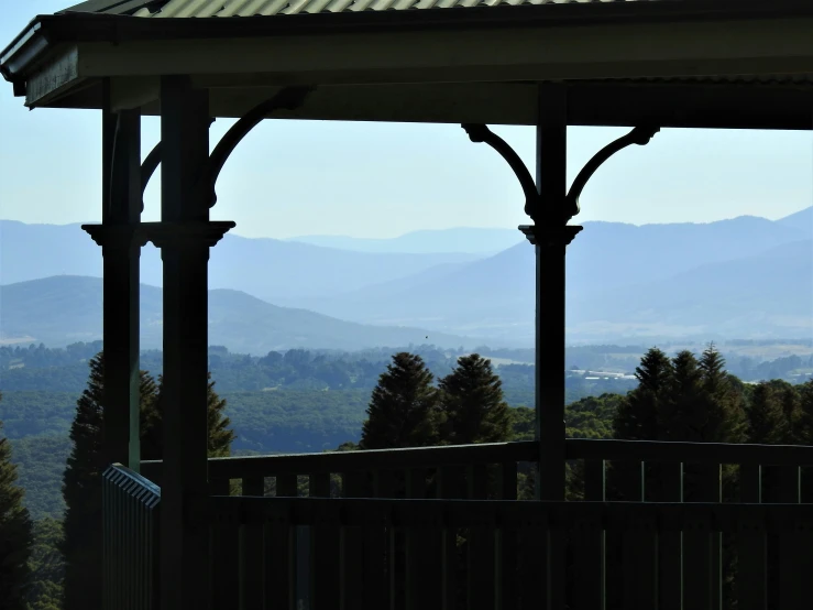 some hills and trees in the distance from a gazebo