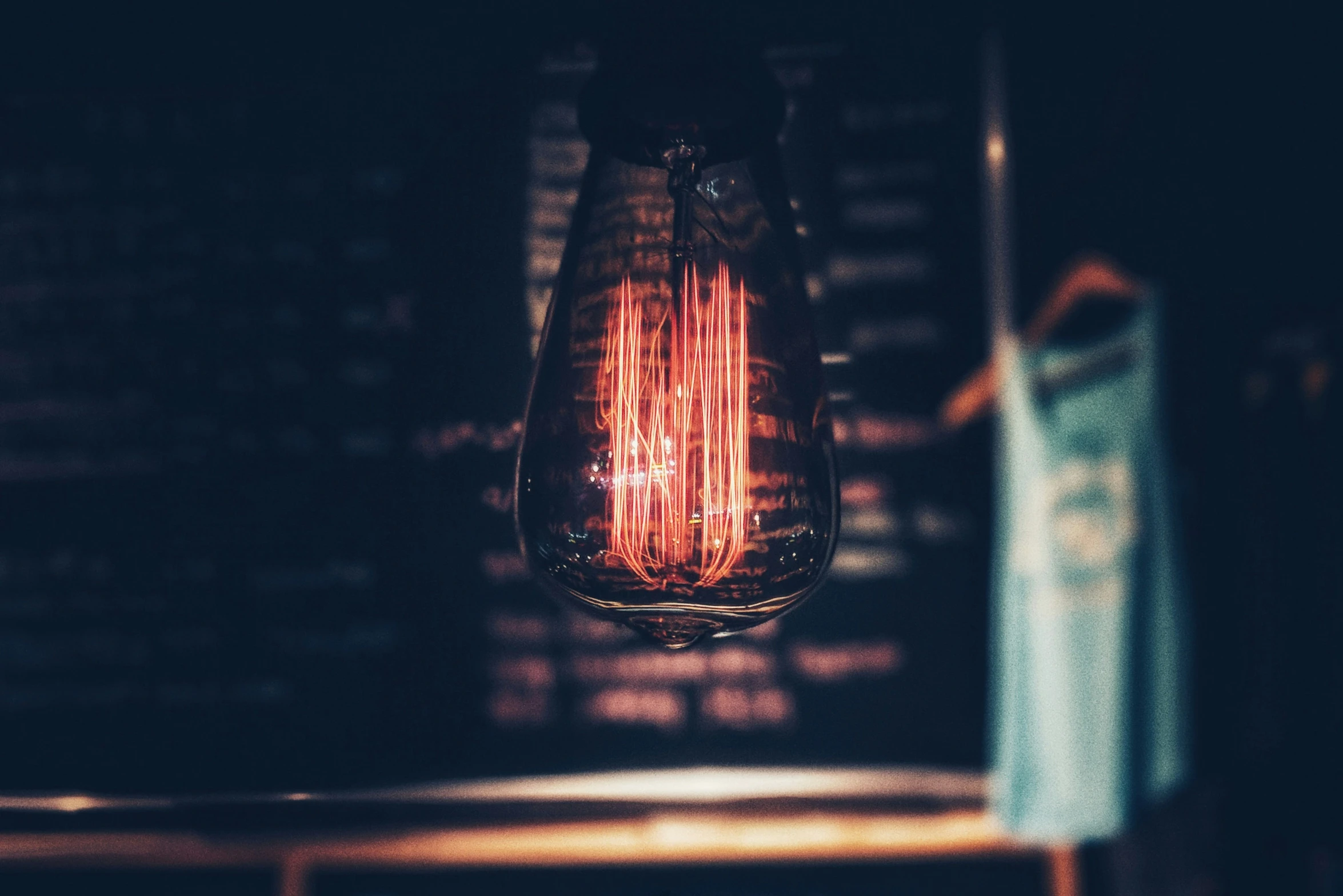 a light bulb on a table in a dark room