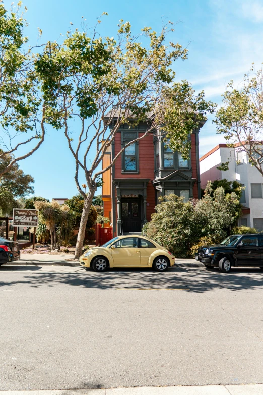 two cars parked on the street with houses behind