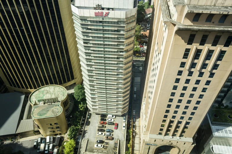 a tall building and a smaller one with trees around