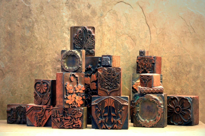 a group of wooden blocks with carving on the sides