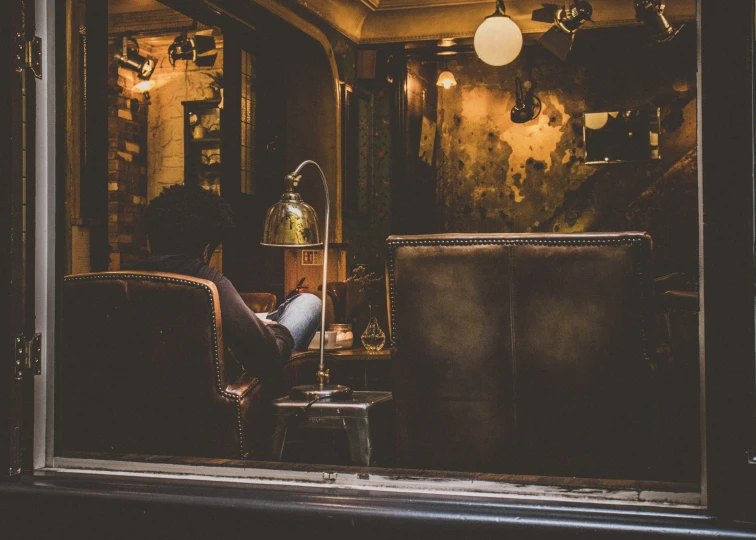 a chair sitting inside of a doorway next to a lamp