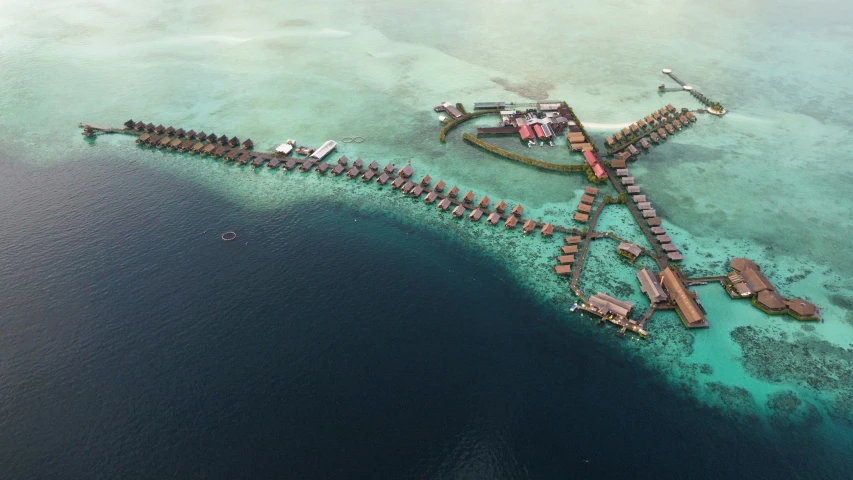 a large body of water surrounded by a pier and houses