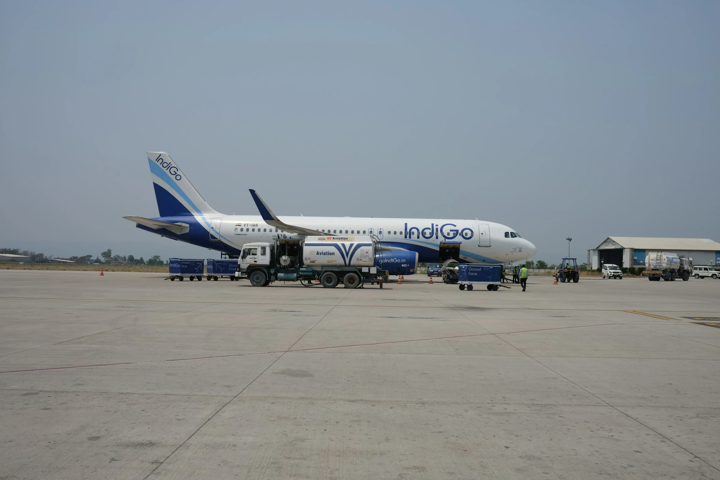 a jumbo jet airliner sitting on top of an airport runway