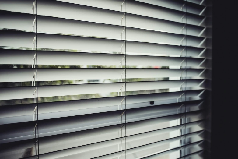 closed shutter blinds with white paint on them