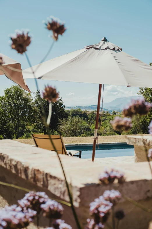 an outdoor patio with chairs and an umbrella