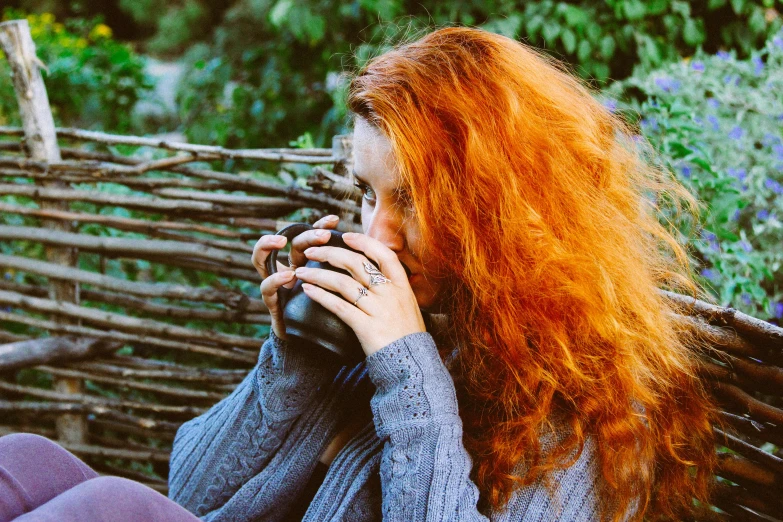 a young woman with red hair talking on a cell phone