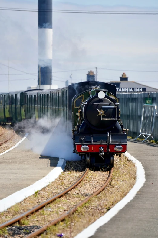 the steam engine of a small train near a town