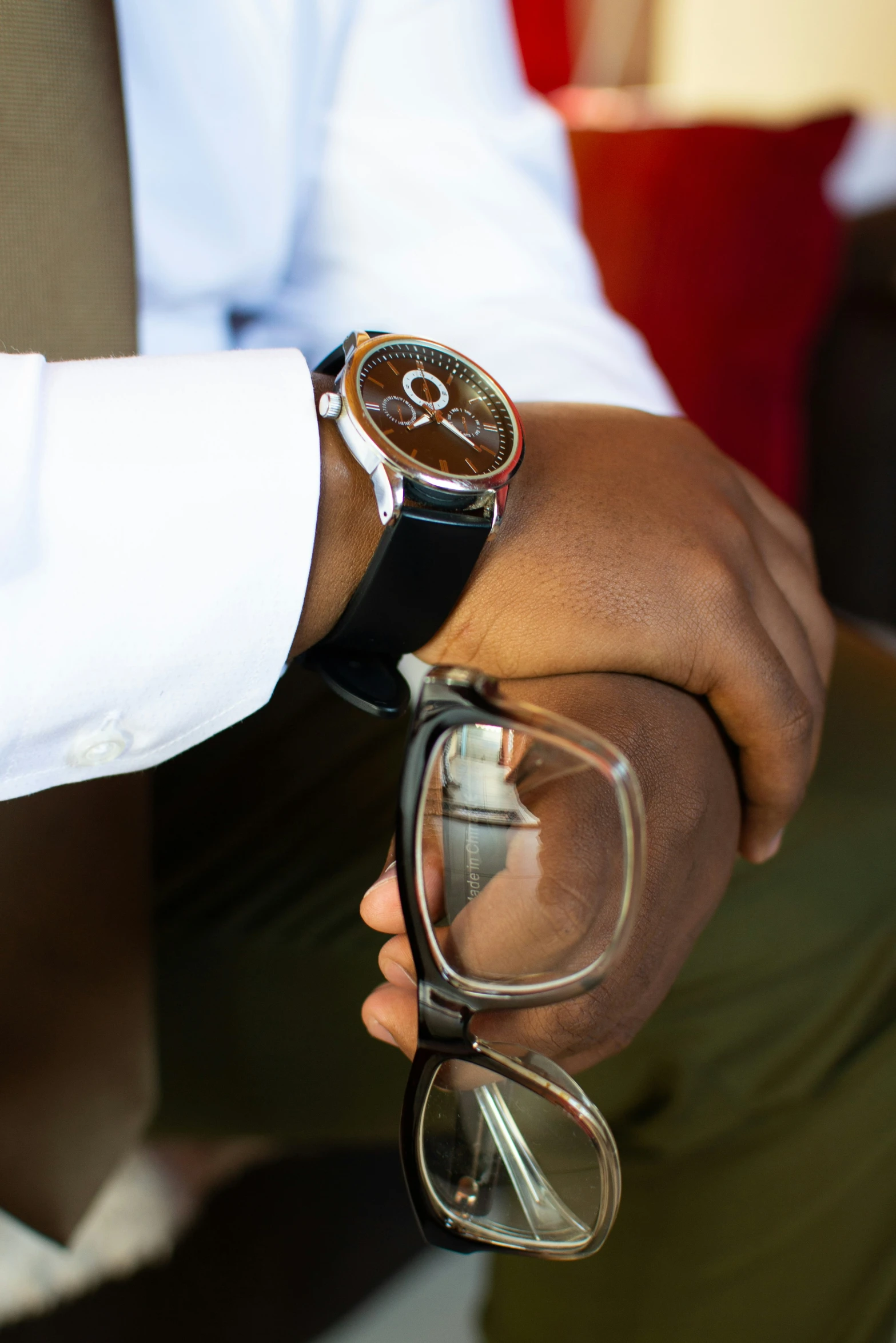 the person has glasses and is wearing a watch