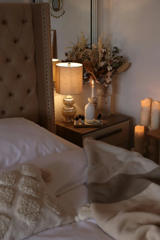 a bedroom with a bed and a night stand with candles