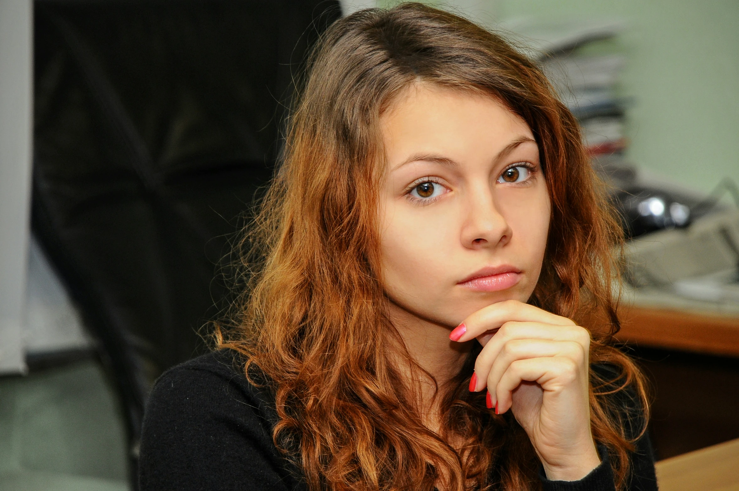 a woman with red hair looking away from the camera