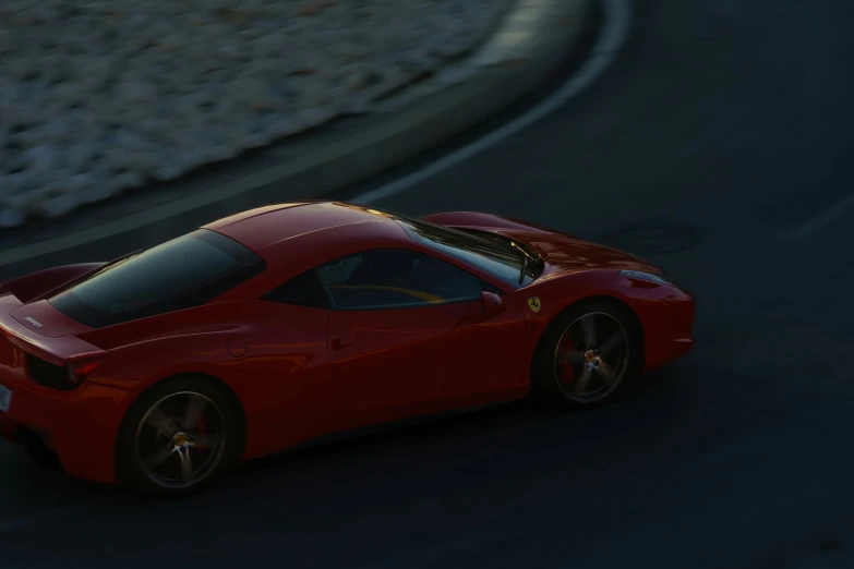 a red sports car speeding down a curved road