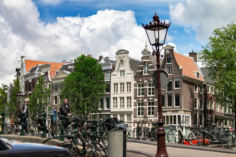 a street lamp with lots of bicycles parked nearby