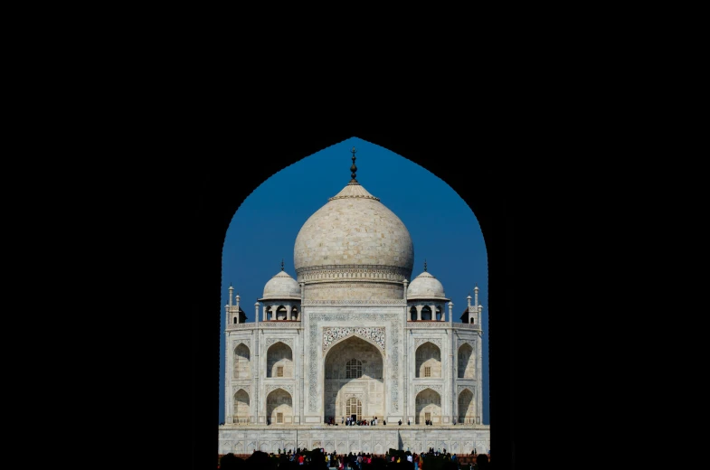 people are looking at the taj from across the water