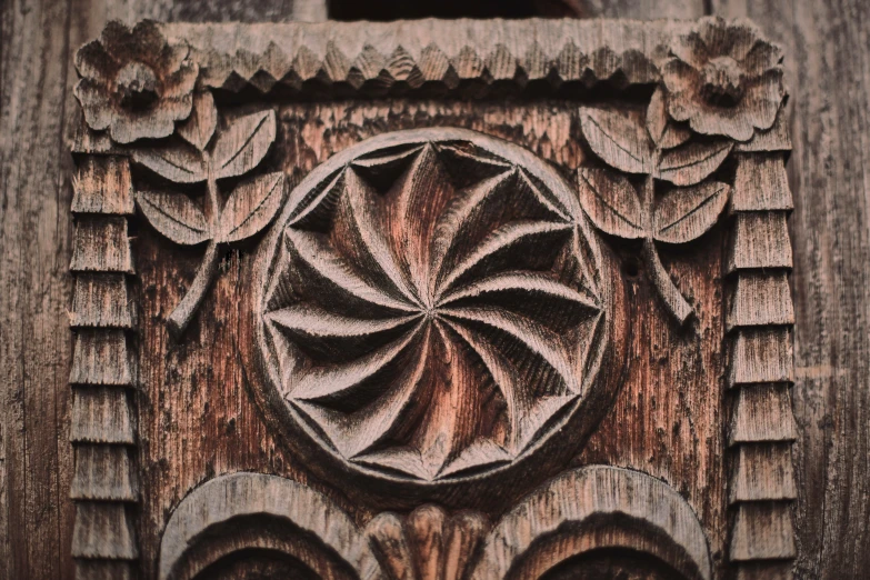 a carved wooden frame on an old building